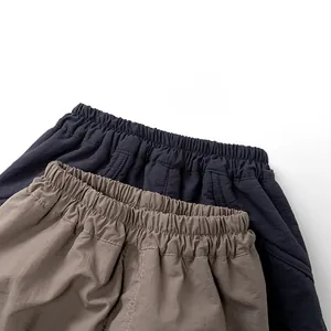Close-up of elastic waistbands and textured fabric on boys fleece cargo pants