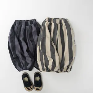 Detailed view of kids thick striped harem pants in grey and beige with soft fleece lining