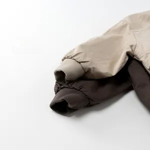 Detail of khaki and brown jacket cuffs with durable cotton fabric and ribbed knit design