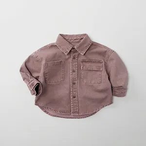 Detail of dusty pink cotton boys' shirt featuring front pockets and clean stitching