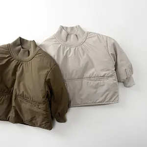 Detailed view of kids' padded pullovers in olive green and beige colors with ribbed cuffs