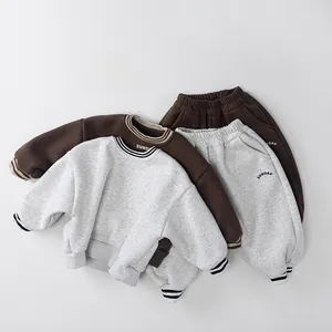 Detailed flat lay of thermal fleece-lined kids jogging suits in brown and grey colors