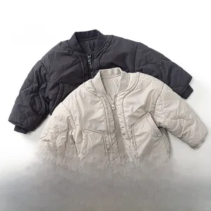 Detail of diamond quilted kids bomber jackets with ribbed collar and metal zippers