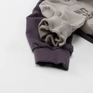 Detail of ribbed cuffs and soft fleece lining on dark purple children's sweatshirts