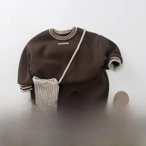 Detail of dark brown kid hoodie with striped ribbing and Sunday graphic print
