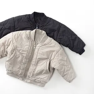Detail of wave-quilted kid's lightweight jacket with ribbed cuffs and large pockets