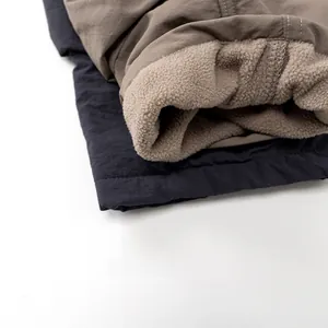 Macro detail of kids winter pants showing thick fleece lining and durable nylon fabric