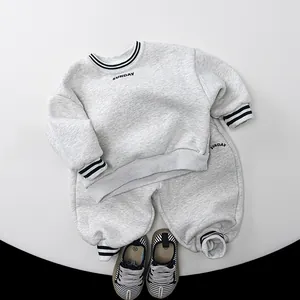Detail view of kids thick fleece grey track suit with ribbed Sunday print and canvas shoes