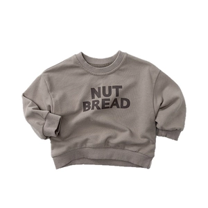 Kids long sleeve crewneck sweatshirt in taupe with black NUT BREAD printed lettering