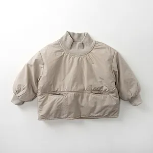 Detail view of the ribbed turtleneck and soft cotton thermal pocket on the beige kid hoodie