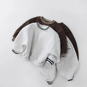 Detailed close-up of thick fleece-lined winter tracksuits with striped ribbed cuffs