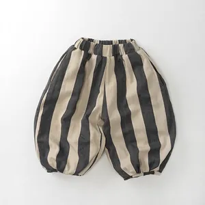 Detailed view of elastic waistband and wide striped texture on children's loose pants