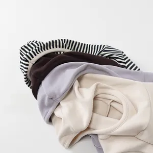 Folded winter thermal undershirts for kids in striped, brown, purple and beige colors