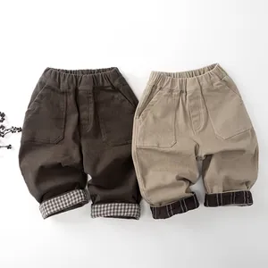 Flat lay of kids thermal pants in dark brown and khaki with plaid cuff detail