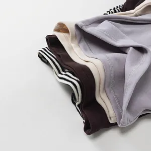 Folded children's hooded thermal tops in assorted colors with soft fleece texture