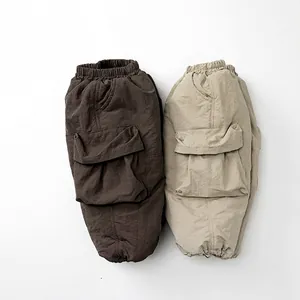 Winter fleece-lined kids cargo pants in brown and sand beige with elastic waist