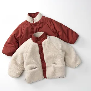 Detail of children's reversible fleece jacket with warm snap-button and contrast colors