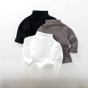Three-piece set of kids turtleneck base layers in black, dark grey, and white cotton