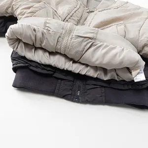 Kids lightweight quilted jacket in beige and black with ribbed hem and metal zipper