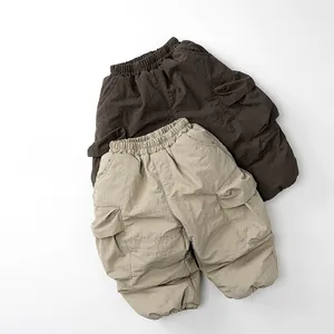 Detail of elastic waist and utility cargo pockets on thick fleece-lined winter kids pants