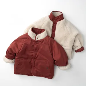 Detail of reversible children's winter jacket with burgundy and beige fleece lining