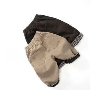 Detail view of kids fleece lined pants with elastic waist and plaid cuffs