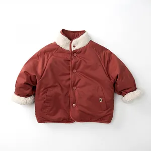 Close-up of kids' reversible padded jacket with retro red fabric and fleece lining
