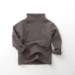Close-up of kids warm taupe turtle-neck shirt with soft textured knitted fabric