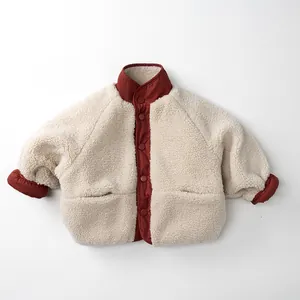 Detail of children's reversible fleece jacket with color-block design and snap buttons