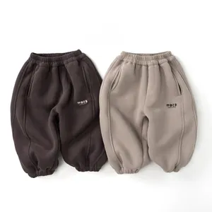 Detail view of winter fleece sweatpants for kids in brown and khaki with elastic cuffs