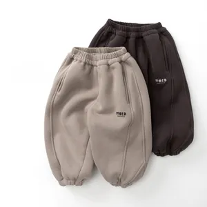 Detail view of kids fleece jogger pants with elastic waist and side word print