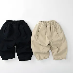 Flat lay of thick fleece-lined winter trousers for kids in black and khaki colors