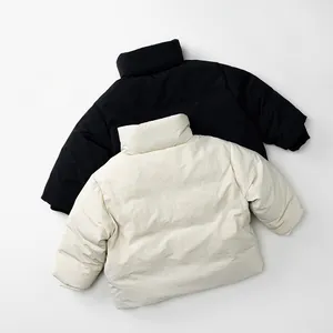 Detailed view of puffed winter down jackets in black and beige with soft matte texture