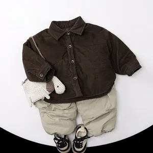 Flat lay of thick brown corduroy shirt jacket with khaki pants and a cute puppy crochet bag