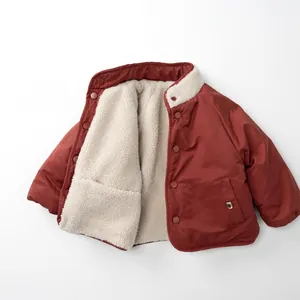 Detail view of winter jacket featuring fleece lining and durable button closure