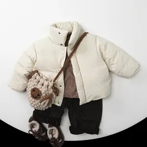 Kids winter outfit set featuring beige puffer jacket and dark brown corduroy trousers