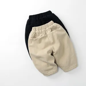 Detailed flat lay of warm fleece-lined kids' joggers in beige and black colors