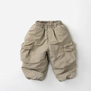 Detailed close-up of khaki winter cargo pants with elastic waist and large side pockets