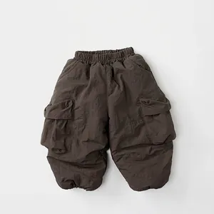 Detail view of dark brown fleece-lined cargo pants with elastic waist and large side pockets