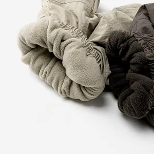 Detail of fleece lining and windproof fabric on khaki and brown winter cargo pants
