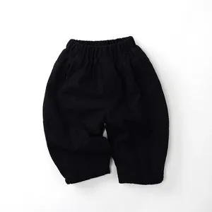 Detail of kids winter fleece-lined trousers with elastic waistband and black cotton fabric