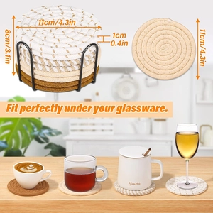 Detailed view of woven cotton coasters in three colors with a black metal storage rack