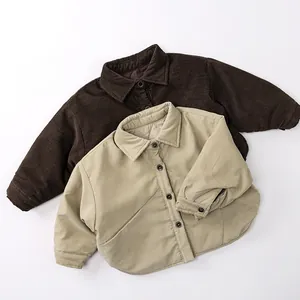 Detailed texture of thick corduroy kids shirts in brown and beige colors