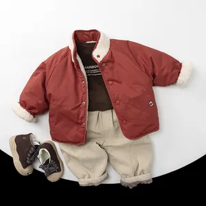 Flat lay of winter toddler outfit with quilted jacket, brown turtleneck and beige pants