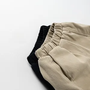 Detail of elastic drawstring waistband and side pockets on thick fleece lined kids pants