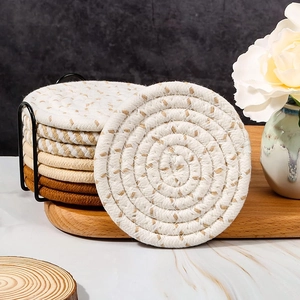 Detailed texture of thick woven cotton rope coasters with black metal storage holder