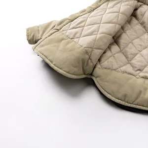 Detailed macro view of beige corduroy fabric with quilted lining for warm kids' jacket