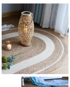 Detail of hand-woven oval jute rug with white stripes on wooden floor in cozy setting