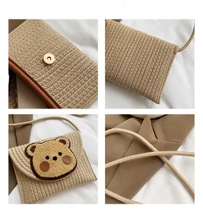 Detail showing the magnetic snap closure and woven texture of the bear straw bag