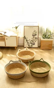 Detail of woven straw cat nests with cute cat ears in cream, grey and green colors